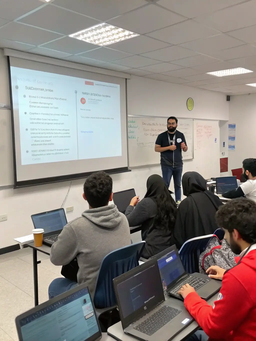 A diverse group of students collaborating on a cybersecurity project, emphasizing teamwork and practical application.